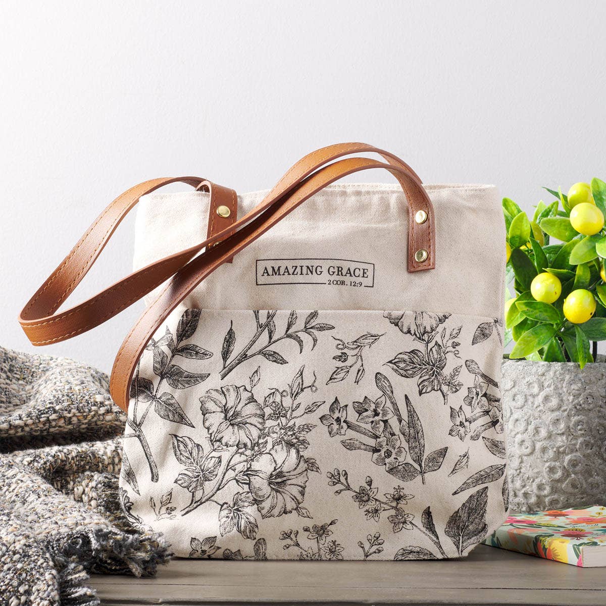 Floral-patterned tote with the verse 2 Corinthians 12:9 and the phrase "Amazing Grace" printed on the front