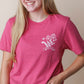Girl wearing a raspberry faith based Christian tshirt with a Bible verse Luke 12:27