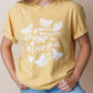 Girl wearing a yellow t-shirt with Christian butterfly design and Bible verse on a beige background